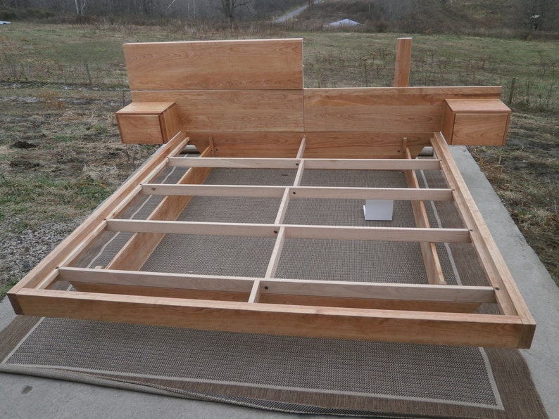 NcFnC03 Low Platform Solid Hardwood Bed with angled base frame and wide Head Board with attached tables; natural color