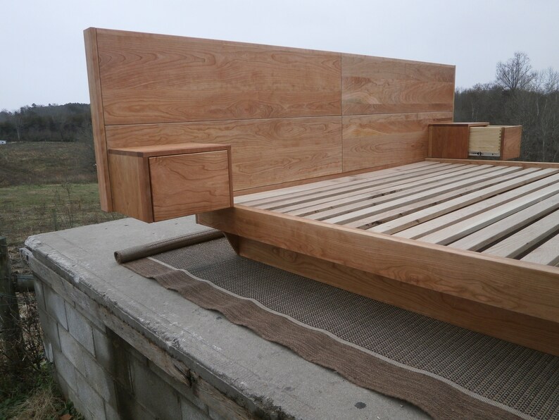 NcFnC03 Low Platform Solid Hardwood Bed with angled base frame and wide Head Board with attached tables; natural color