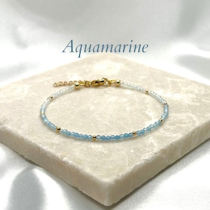 Aquamarine dainty beaded bracelet with gold spacers