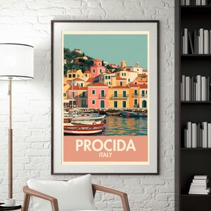May include: A framed travel poster featuring Procida, Italy. The artwork depicts colorful buildings along a harbor, with boats and a teal sky. The poster has the word "PROCIDA" and "ITALY" in a peach-colored banner.