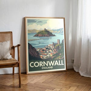 May include: A framed travel poster for Cornwall, England, featuring a coastal town with a castle and a bridge leading to an island. The poster has a vintage style with a green and white color scheme. The word "Cornwall" is prominently displayed.