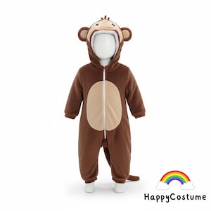 May include: Brown monkey costume for a baby or toddler. The hooded jumpsuit features a tan face and belly, with a zip closure. The costume includes a tail and is designed to look like a monkey. The HappyCostume logo is in the bottom right corner.