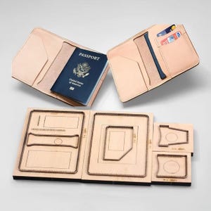 May include: A light tan leather passport holder with a blue passport inside and a separate leather wallet with credit cards. Below are leathercraft cutting dies in various shapes and sizes.