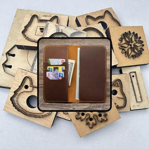 May include: A brown leather wallet with card slots and cash, surrounded by wooden die-cut shapes. The wallet is open, revealing cards and folded bills. The die-cut shapes include animal and snowflake designs.
