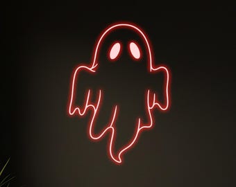 May include: A red neon ghost sign is mounted on a dark wall. The ghost has two eye holes and a wavy bottom. The scene includes a small table, two chairs, and a potted plant, creating a spooky Halloween ambiance.