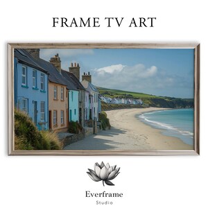 May include: A framed print of a coastal scene featuring colorful houses along a beach. The houses are painted in shades of blue, orange, and teal. The text "FRAME TV ART" is at the top, and the Everframe Studio logo is at the bottom.
