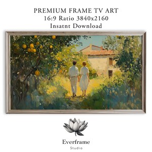 May include: A framed landscape painting depicts a couple walking hand-in-hand on a sunlit path towards a house. The artwork features a warm color palette with oranges, greens, and yellows. The text "PREMIUM FRAME TV ART" is at the top.