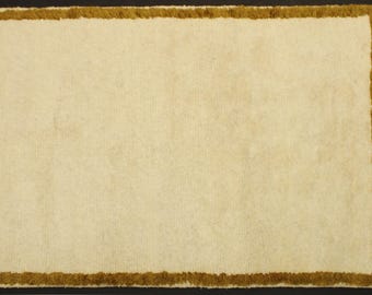 Handmade Beige Wool Rug: Minimalist Border, Tasseled Area Rug