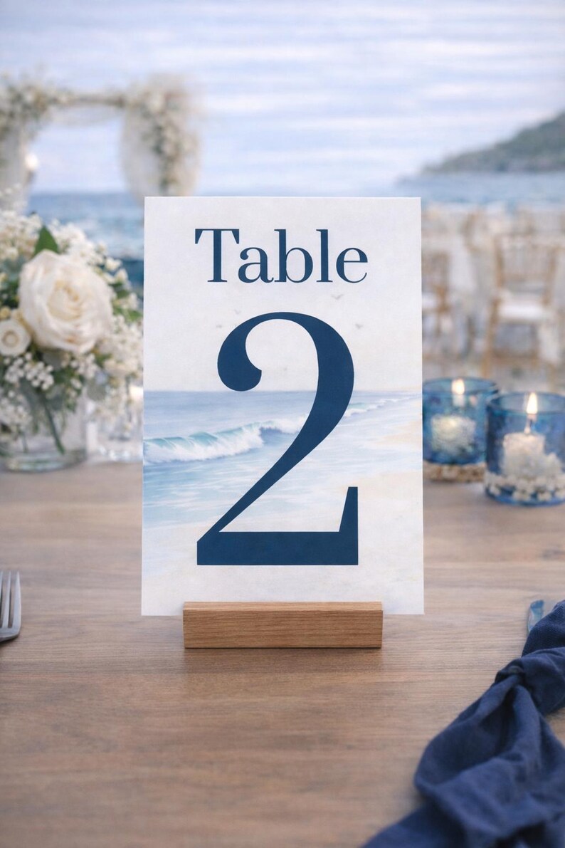 Ocean wedding signs bundle featuring a coordinated set of 13 printable ceremony and reception signs, including welcome sign, seating chart, timeline, bar signs, guest book, cards and gifts, favors, reserved, unplugged ceremony, and table numbers. Soft blue ocean background with elegant coastal typography creates a romantic beach and destination wedding look. Fully editable in Canva and available in multiple sizes, perfect for seaside, coastal, and tropical weddings.