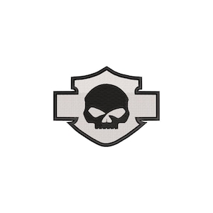 May include: A shield-shaped embroidered patch featuring a white background with a black border and a central black skull graphic. The design includes horizontal extensions on both sides, creating a stylized emblem with a clean, stitched texture.