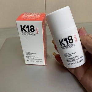 May include: A white K18 Biomimetic Hairscience leave-in molecular repair hair mask with a matching orange box. The box and bottle have the K18 logo and product information. The bottle contains 1.7 fl oz of product.