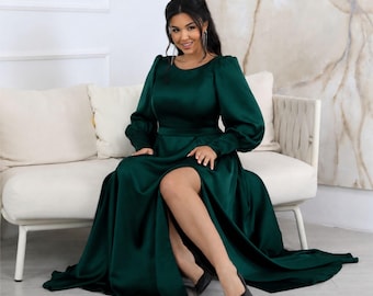 Green satin maxi dress: long sleeves, zipper cuffs, lace-up corset back, slit, pockets.