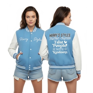 May include: A light blue and white varsity jacket featuring the text "Harry Styles" on the front and "Harry's Styles Together Together Treat People With Kindness" on the back. The jacket has white sleeves and striped detailing.