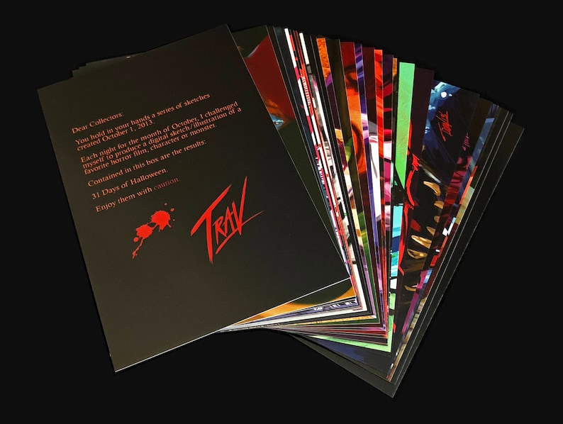 May include: A black and red card with the text "Dear Collectors" and "31 Days of Halloween" and the word "TRAV" in red. The card is part of a stack of cards with colorful illustrations.