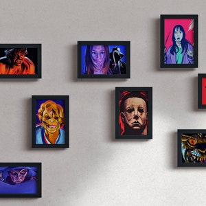 May include: A wall gallery of framed horror movie character portraits. The portraits are in a black frame and feature characters from classic horror films such as Freddy Krueger, Jason Voorhees, and Michael Myers.