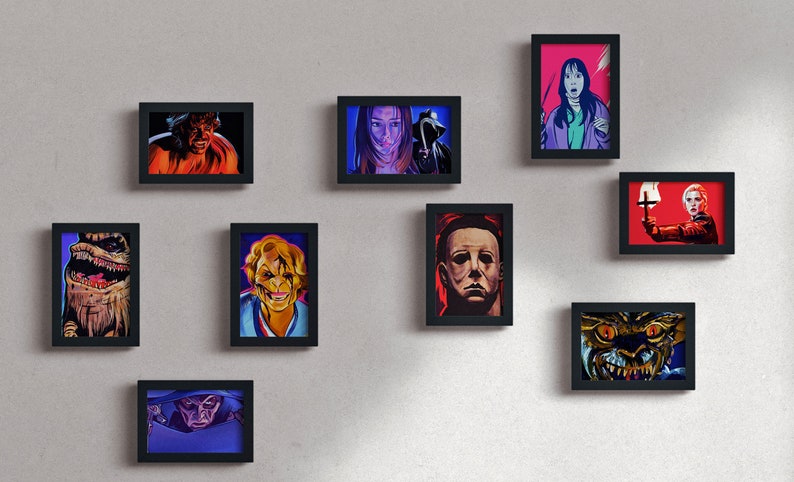 May include: A wall gallery of framed horror movie character portraits. The portraits are in a black frame and feature characters from classic horror films such as Freddy Krueger, Jason Voorhees, and Michael Myers.