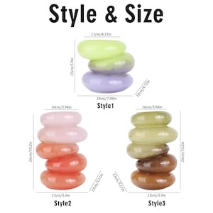 May include: The image displays three stacks of smooth, oval-shaped stones in various colors: green, purple, pink, orange, and brown. The text "Style & Size" is at the top. Measurements are provided in inches and centimeters, with the stacks measuring up to 10.2 inches tall.