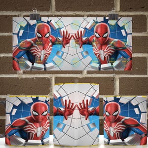 May include: A ceramic mug featuring a graphic print of a red and blue superhero character with a white spider emblem on the chest. The character is depicted with hands pressed against a shattered wall effect with a blue grid background pattern.