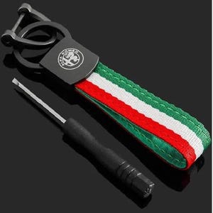 May include: Black metal Alfa Romeo keyring with a red, white, and green striped strap. The keyring includes a metal clasp and a small screwdriver. The Alfa Romeo logo is visible on the metal plate.