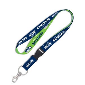 May include: A lanyard featuring the Seattle Seahawks logo and team name in white on a navy blue background. The lanyard also has a green and white section. It includes a black plastic clasp and a metal clip.
