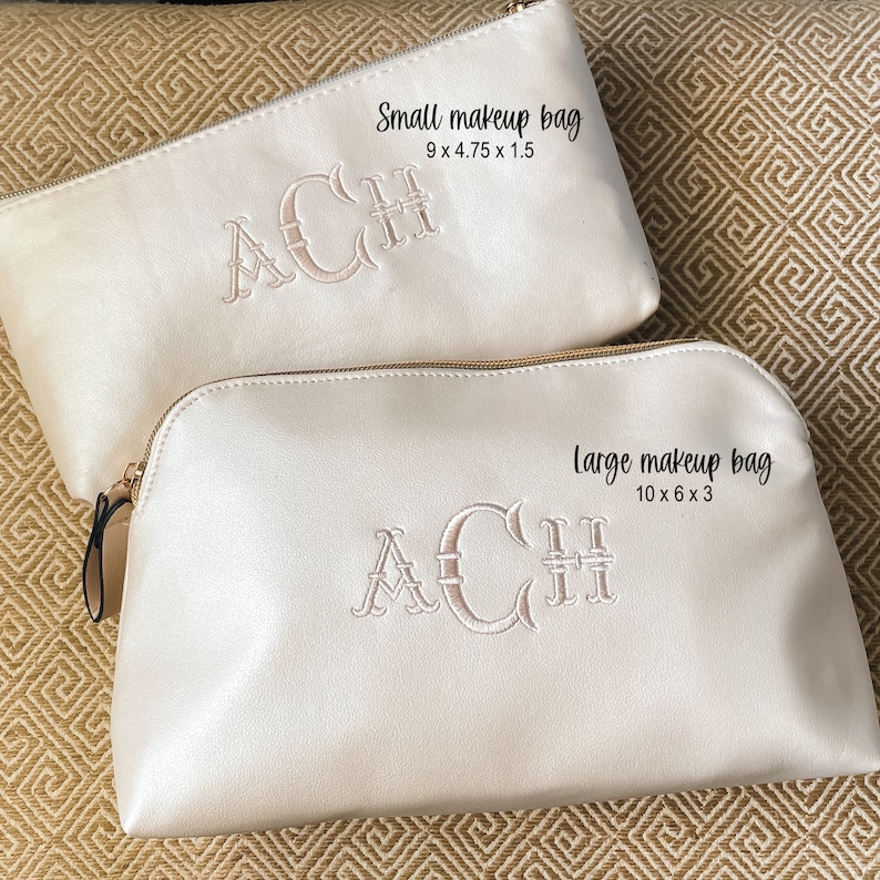 May include: Two off-white makeup bags with gold zippers and embroidered initials. The smaller bag measures 9 x 4.75 x 1.5 inches, and the larger bag is 10 x 6 x 3 inches. The text "Small makeup bag" and "Large makeup bag" are visible.