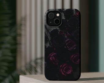 May include: Black phone case featuring a dark floral design of roses in shades of black and deep red. The case has a matte finish and a camera cutout. The phone case is on a light-colored surface.
