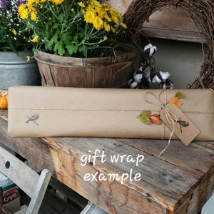 May include: A set of three ceramic mugs with a speckled, matte finish. The mugs are in shades of gray, white, and black. Each mug has a simple, modern design and a rounded handle. The mugs are stacked on top of each other.