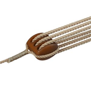 May include: A beige twisted rope assembly featuring a brown plastic cord lock with three distinct channels. The rope strands pass through the channels of the cord lock and are secured on one side by a tightly wrapped section of thinner beige cord.