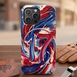 May include: A smartphone case featuring a vibrant, abstract paint-swirl design in shades of red, white, and blue. The pattern incorporates a prominent number 17 integrated into the fluid, marbled texture, covering the entire back of the device.