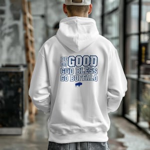 Puede incluir: Sudadera con capucha blanca con texto azul en la espalda que dice "BE DO GOOD GOD BLESS GO BUFFALO" con un gr&aacute;fico de b&uacute;falo. La sudadera tiene una capucha con cord&oacute;n y un bolsillo de canguro.
