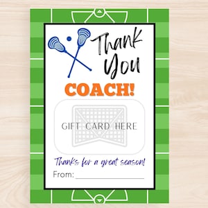 May include: A lacrosse-themed gift card holder with a green field design. The card features crossed lacrosse sticks, the words "Thank You COACH!", and space for a gift card. Includes the text "Thanks for a great season!"