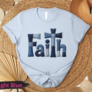A light blue t-shirt with the word "Faith" printed on it, along with a straw hat and a fan, all arranged on a woven mat.