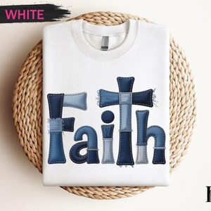 A white t-shirt with the word "Faith" printed in a stylized font made up of blue denim patches.