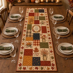 May include: A rectangular fabric table runner featuring a patchwork design of autumn-themed patterns, including maple leaves, pumpkins, and a wheelbarrow, with the text "Fall is my favorite color" centered on a cream background with a leaf border.