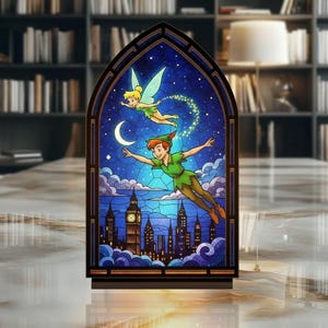 May include: A stained glass panel depicting Peter Pan and Tinkerbell soaring above London at night. The artwork is set against a dark blue sky with a crescent moon and stars. The panel is framed in a dark, arched shape.