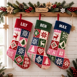 May include: Three Christmas stockings hanging in a row, each featuring a colorful patchwork knit pattern of reindeer, snowflakes, trees, and hearts. The stockings have solid-colored cuffs with the white embroidered names LILY, BEN, and MAX.