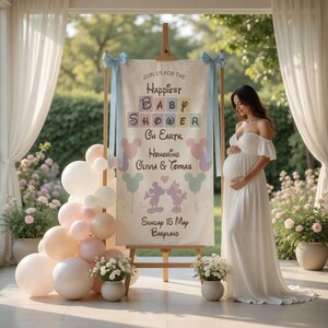 May include: A baby shower scene with a sign that reads "Join us for the Happiest Baby Shower on Earth. Honoring Olivia & Tomas." The sign is on an easel, decorated with blue ribbons. A pregnant person in a white dress stands nearby. Balloons and flowers complete the scene.