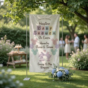 May include: A cream-colored baby shower banner with the text "Join us for the Happiest Baby Shower on Earth. Honoring Olivia & Tomas." Mickey Mouse balloons and characters are featured. The banner is displayed outdoors on a sunny day.