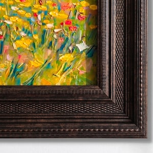 May include: An oil painting featuring a vibrant field of wildflowers in shades of yellow, red, and blue, rendered with thick, textured brushstrokes. The artwork is encased in a dark brown, ornate wooden frame with a detailed, cross-hatched border.
