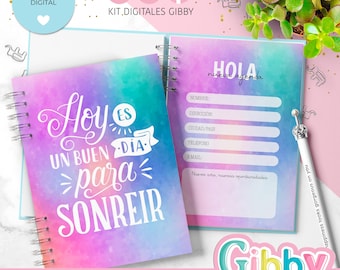 May include: A spiral-bound planner with a watercolor design in shades of purple, blue, and green. The cover features the text "Hoy es un buen día para sonreír." The open page displays a section for personal information. A pen with a decorative top is included.