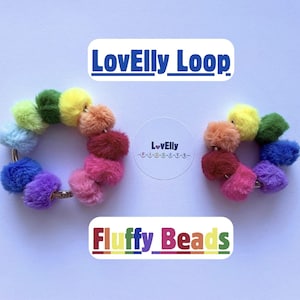 May include: Two circular rings made of multi-coloured, fuzzy pom-pom beads in shades of blue, green, yellow, orange, pink, and purple. The text LovElly Loop and Fluffy Beads appears in the image, along with a circular logo reading LovElly Fidgets.