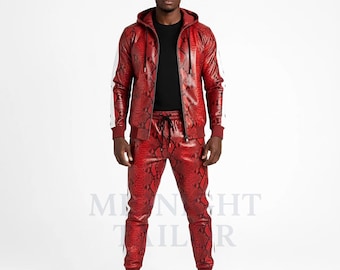 May include: A red snakeskin-patterned tracksuit featuring a hooded jacket with white stripes on the sleeves and matching drawstring pants. The outfit is worn with a black shirt and white sneakers. The overall style is bold and fashionable.