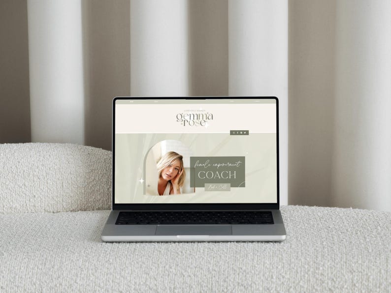 May include: A silver laptop displaying a website with the text "gemma pose" and the words "hand reparent coach". The website features a photo of a woman with blonde hair. The laptop is on a white textured surface.
