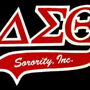 May include: A red and white Delta Sigma Theta Sorority, Inc. emblem on a black background. The emblem features the Greek letters Delta, Sigma, and Theta, along with the words "Sorority, Inc." in a banner.