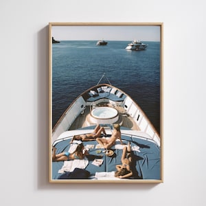 May include: A framed print featuring a yacht with people sunbathing on the deck. The yacht has a jacuzzi and is surrounded by other boats on the water. The deck is covered in blue fabric.