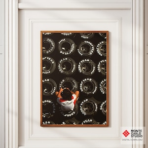 May include: A framed print featuring a person sitting among a backdrop of Goodyear Eagle tires. The person is wearing a red and white shirt with the Marlboro logo. The print is in a brown frame.