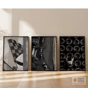 May include: Set of three framed black and white prints. One shows a checkered flag, another depicts race cars on a track, and the third features a pattern of tires. The prints are displayed on a neutral wall.