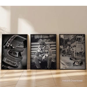 May include: Three framed monochrome prints with Formula 1 racing themes. One shows a racing helmet close-up, another a driver, and the third a race scene. The prints are displayed on a light-coloured wall.