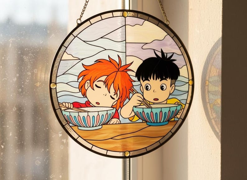 May include: Circular stained glass window depicting two cartoon children eating from bowls with chopsticks. One child has orange hair and is asleep. The other child has black hair and is awake. The background shows a landscape with clouds and mountains.