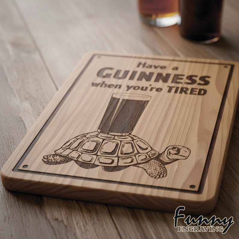 May include: Wooden chopping board with a carved design. The design features a turtle with a pint of Guinness as its shell, and the text "Have a Guinness when you're TIRED". The board has a rectangular shape with a beveled edge.